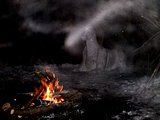 a snow figure in a winter forest at night by a bonfire