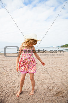 Young barefoot girl at beach