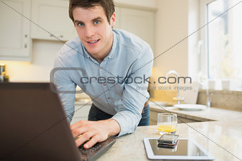 Man using laptop wirth smartphone and tablet