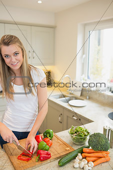 Woman cutting mixed peppers
