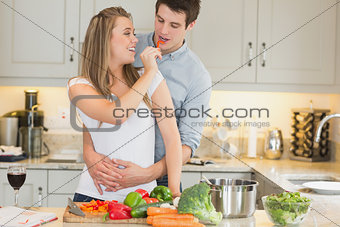 Woman feeding man jokingly