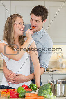Woman having fun by feeding man