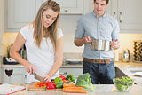 Man helping woman with cooking
