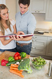 Couple reading cookery book