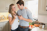 Couple in the kitchen drinking a glass of red wine