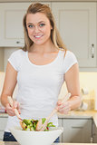 Woman tossing salad