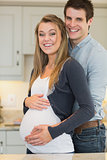 Man embracing pregnant partner