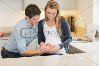 Man touching partners pregnant belly