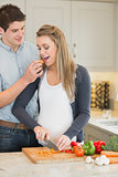 Man feeding his pregnant wife