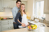 Man with  pregnant wife in the kitchen