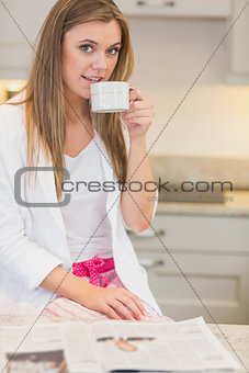 Woman wearing  pyjamas and drinking a beverage