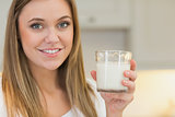 Happy woman holding glass of milk