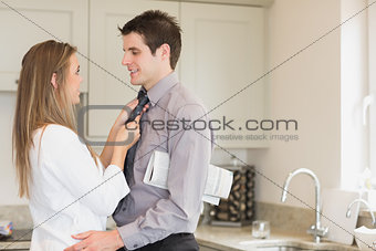 Wife fixing husbands tie