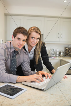 Couple typing on the notebook