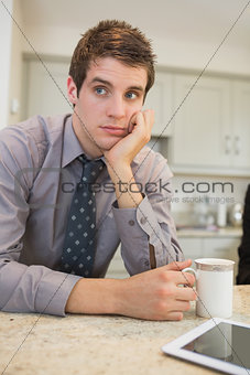 Man thoughtfully drinking a coffee