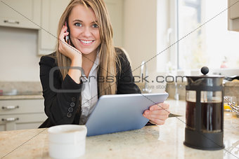 Smiling woman with tablet and mobile phone