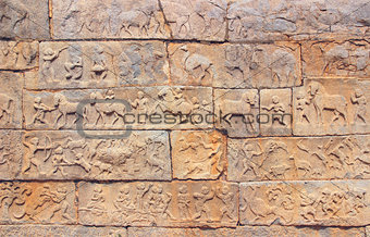 Wall with a carved relief: scenes of hunting and life. India