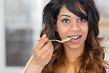 Woman holding a spoon with cereal