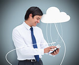 Businessman holding a tablet computer connected to cloud computing