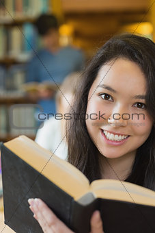 Student in library reading book