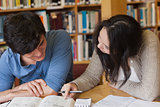 Two students learning in a library