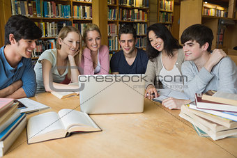 Group of students learning in a library