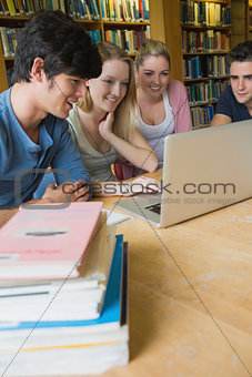 Four students studying in a library