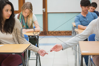 Two students cheating in the classroom