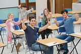 Students in classroom giving thumbs up