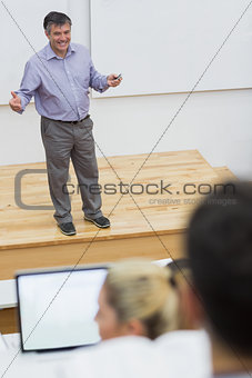 Explaining teacher standing in a lecture hall