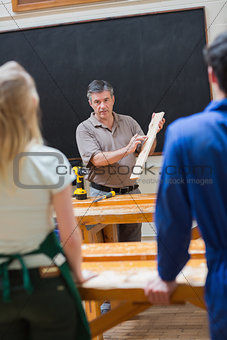 Explaining teacher and the woodwork class