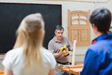Teacher of a woodwork class teaching two students