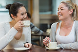 Two laughing students in college coffee shop