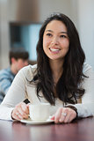 Smiling student sitting in a coffee shop