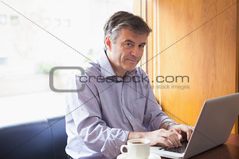 Man in a coffee shop using the laptop