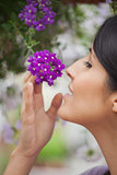 Woman smelling purple flower