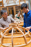 Teacher and a student in a woodworking class working on a frame