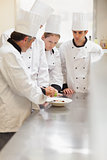 Trainees listening to the head chef
