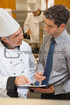 Chef and waiter having a discussion
