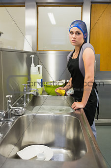 Unhappy woman washing the dishes