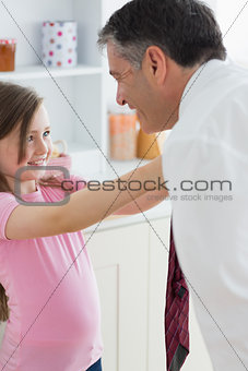 Daughter fixing her fathers tie