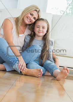 Smiling mother and daughter embracing