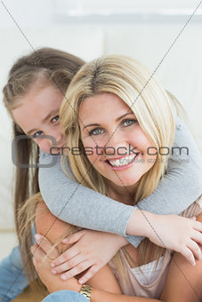 Daughter hugging her mother from behind