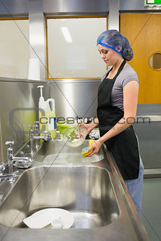 Woman using sponge for dishes