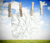 White crumpled paper hung on a laundry line