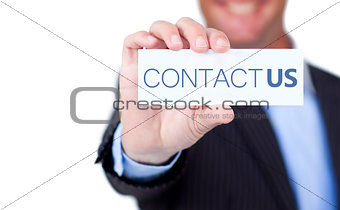 Businessman holding a label with contact us written on it