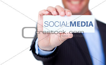 Businessman holding a label with social media written on it
