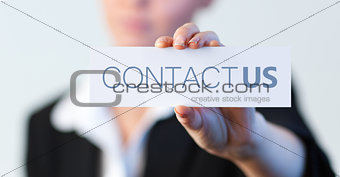 Businesswoman holding a label with contact us written on it