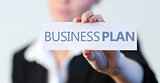 Businesswoman holding a label with business plan written on it