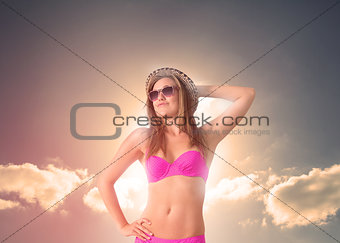 Woman wearing a straw hat relaxing under the sun